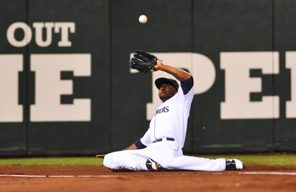 May 7, 2011; Seattle, WA, USA; Seattle Mariners left fielder Milton Bradley (15) slides and catches a Chicago White Sox foul ball in the ninth inning at Safeco Field. Chicago beat Seattle 6-0.