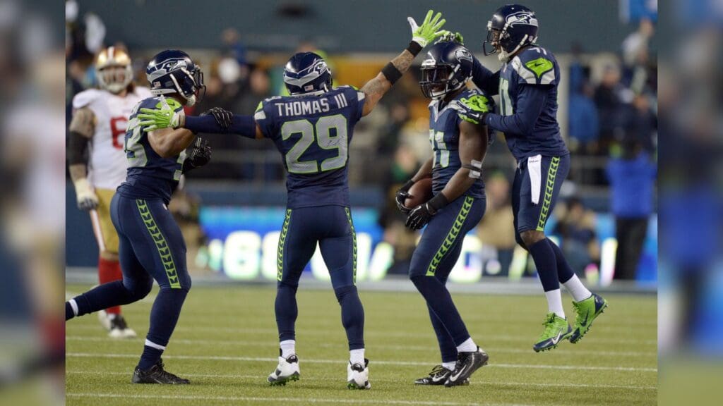 Jan 19, 2014; Seattle, WA, USA; Seattle Seahawks strong safety Kam Chancellor (31) celebrates with his teammates after making an interception against the San Francisco 49ers during the second half of the 2013 NFC Championship football game at CenturyLink Field.