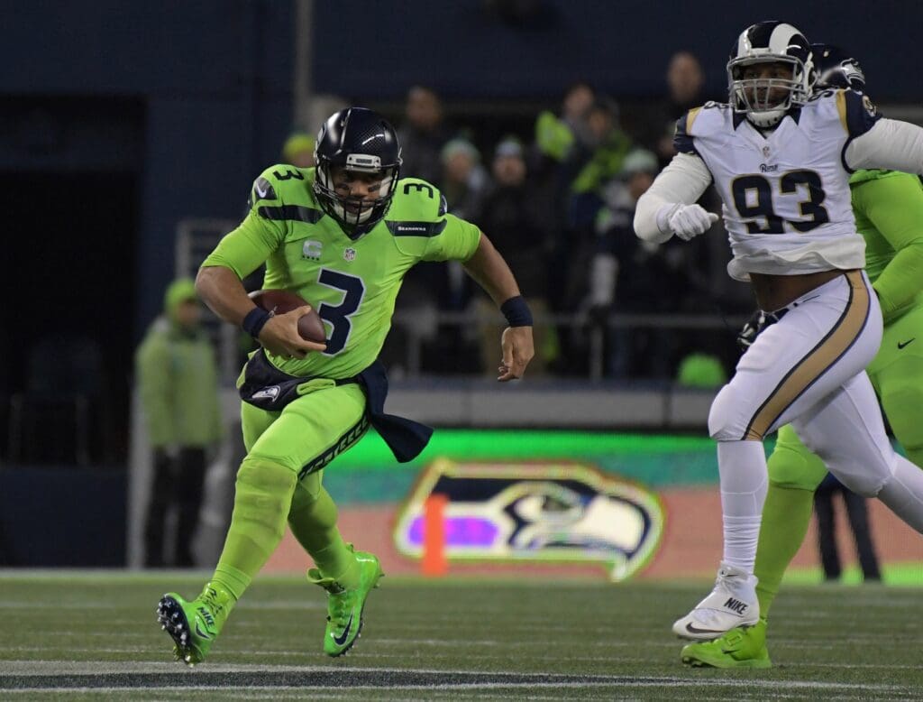 Dec 15, 2016; Seattle, WA, USA; Seattle Seahawks quarterback Russell Wilson (3) is pursued by Los Angeles Rams defensive tackle Ethan Westbrooks (93) during a NFL football game at CenturyLink Field.