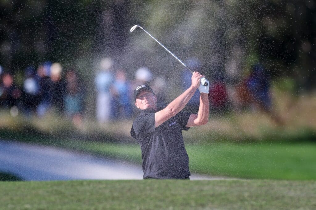 Dec 21, 2024; Orlando, Florida, [USA]; Steve Stricker hits a shot out of the bunker on the 18th hole during the PNC Championship at The Ritz-Carlton Golf Club.