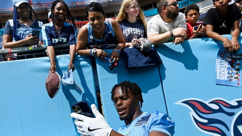 Tennessee Titans wide receiver Jha'Quan Jackson (19) takes a selfie with fans during “Back Together Weekend” training camp practice at Nissan Stadium Saturday, July 26, 2025, in Nashville, Tenn.