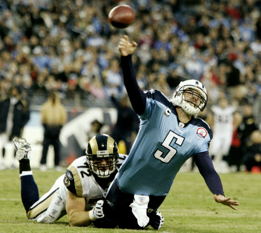 Tennessee Titans quarterback Kerry Collins (5) is pulled down by St. Louis Rams defensive end Chris Long (72) in the second quarter at LP Field Dec. 13, 2009. The Titans beat up on the Rams 47-7. 091213