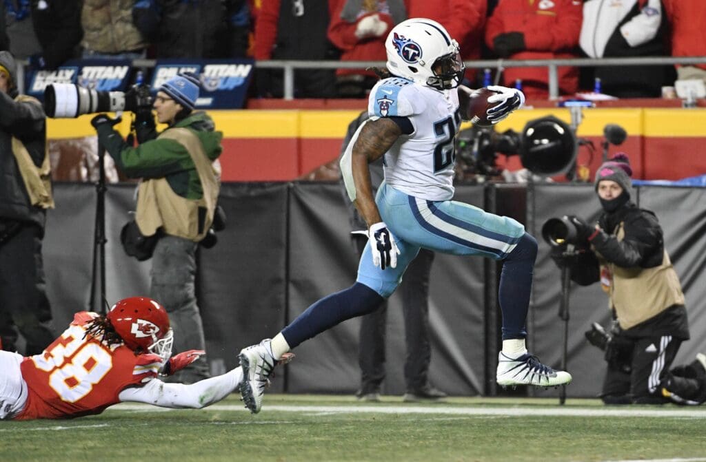 Jan 6, 2018; Kansas City, MO, USA; Tennessee Titans running back Derrick Henry (22) gets pats Kansas City Chiefs free safety Ron Parker (38) to score a touchdown during the fourth quarter in the AFC Wild Card playoff football game at Arrowhead Stadium.