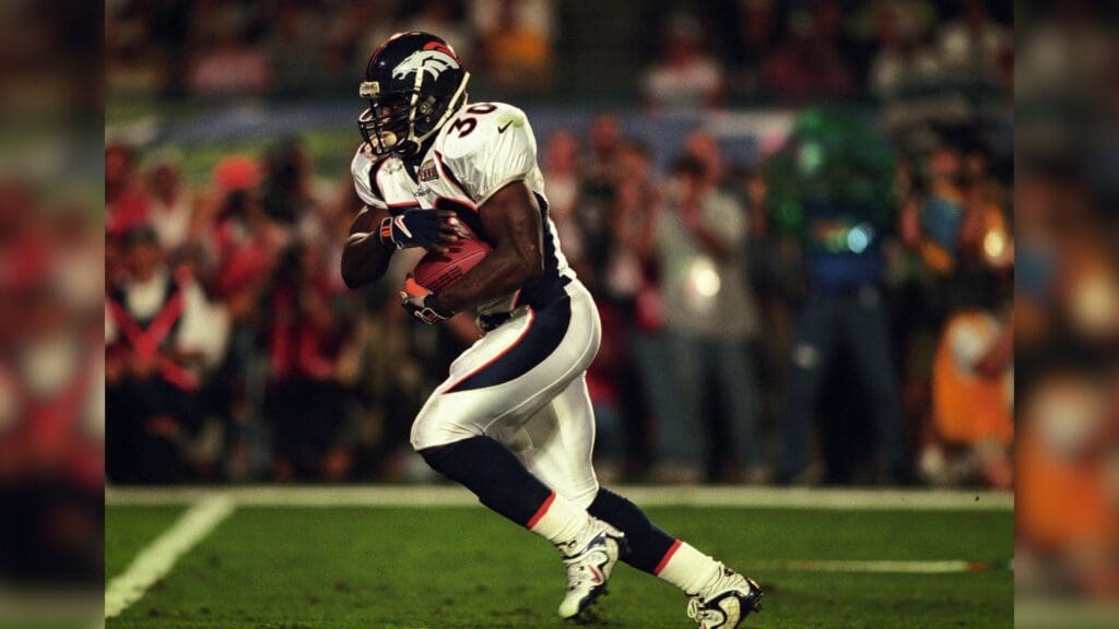 Jan 31, 1999; Miami, FL, USA; FILE PHOTO; Denver Broncos running back Terrell Davis (30) carries the ball against the Atlanta Falcons during Super Bowl XXXIII at Dolphin Stadium. The Broncos defeated the Falcons 34-19.
