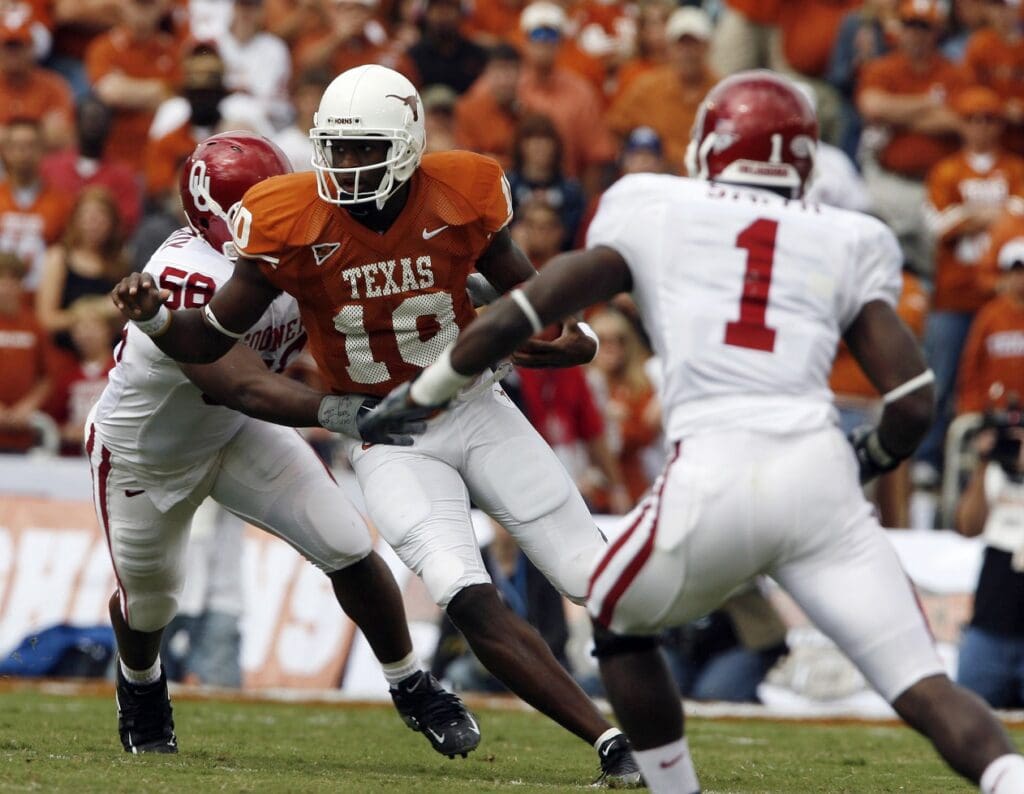 Oct 8, 2005; Dallas, TX, USA; Texas Longhorns quarterback #10 Vince Young runs against Oklahoma Sooners #50 Jon Cooper and #1 Reggie Smith in the first quarter during Red River Shootout at Cotton Bowl.