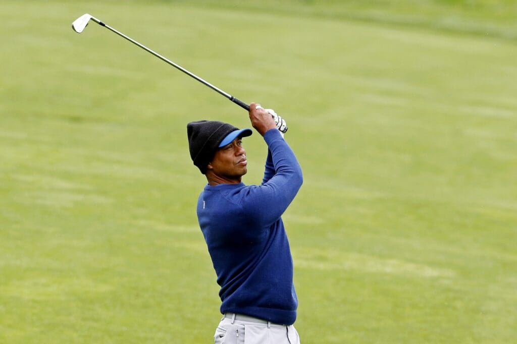 May 13, 2019; Farmingdale, NY, USA; Tiger Woods plays from the fairway on the ninth hole during a practice round for the PGA Championship golf tournament at Bethpage State Park - Black Course.