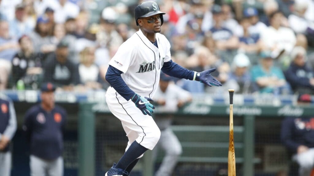 Jul 27, 2019; Seattle, WA, USA; Seattle Mariners left fielder Tim Beckham (1) flips his bat after hitting an RBI double against the Detroit Tigers during the fifth inning at T-Mobile Park.