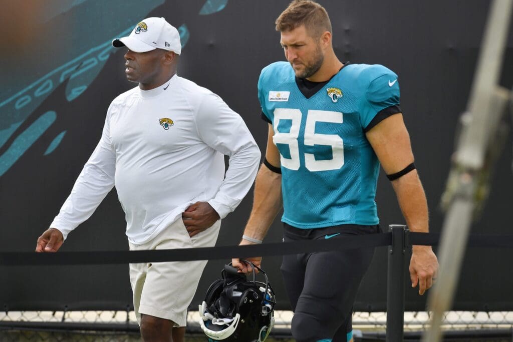 Charlie Strong, the Jaguars Assistant Head Coach and Inside Linebackers Coach and TE (85) Tim Tebow walk from the stadium at the start of training camp at the practice fields outside TIAA Bank Field in Jacksonville, FL Tuesday, August 3, 2021. Tuesday was the first day of players wearing pads for practice. Jki 080321 Jagspadstrainingcamp 02