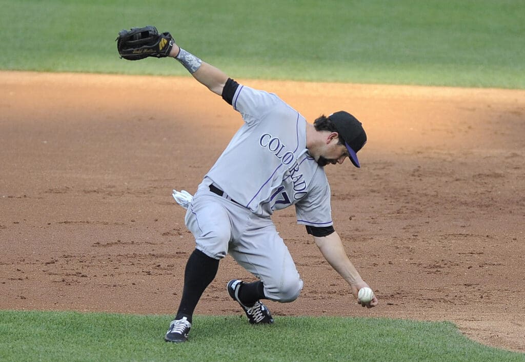 July 4, 2012; St. Louis, MO. USA; Colorado Rockies first baseman Todd Helton (17) bobbles a slow roller hit by St. Louis Cardinals shortstop Rafael Furcal (not pictured) in the second inning at Busch Stadium.