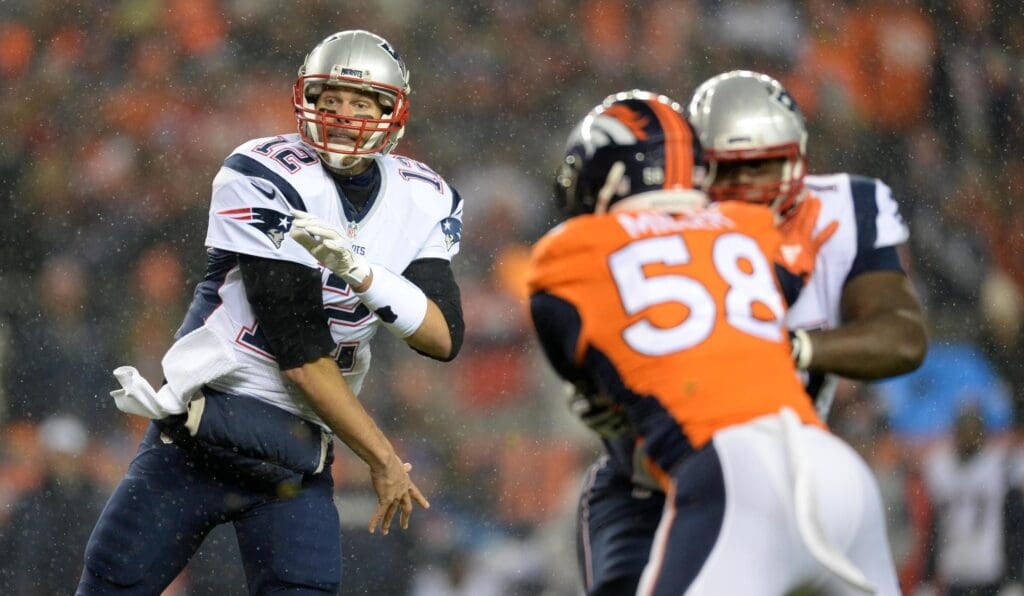 Nov 29, 2015; Denver, CO, USA; New England Patriots quarterback Tom Brady (12) throws a pass in the first quarter against the Denver Broncos at Sports Authority Field at Mile High.