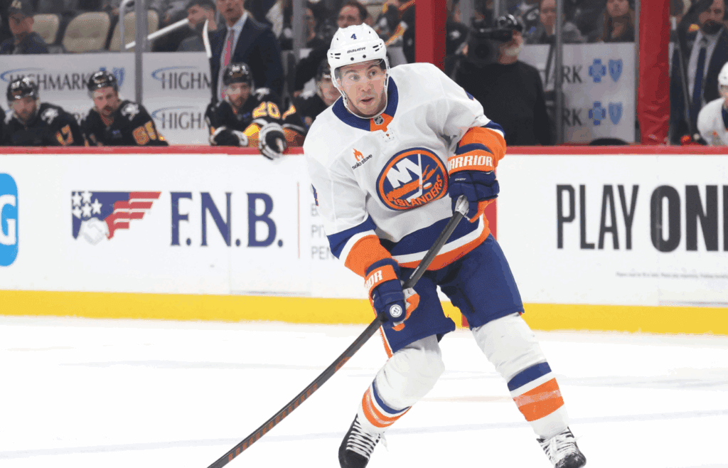 Mar 18, 2025; Pittsburgh, Pennsylvania, USA; New York Islanders defenseman Tony DeAngelo (4) shoots the puck against the Pittsburgh Penguins during the second period at PPG Paints Arena.