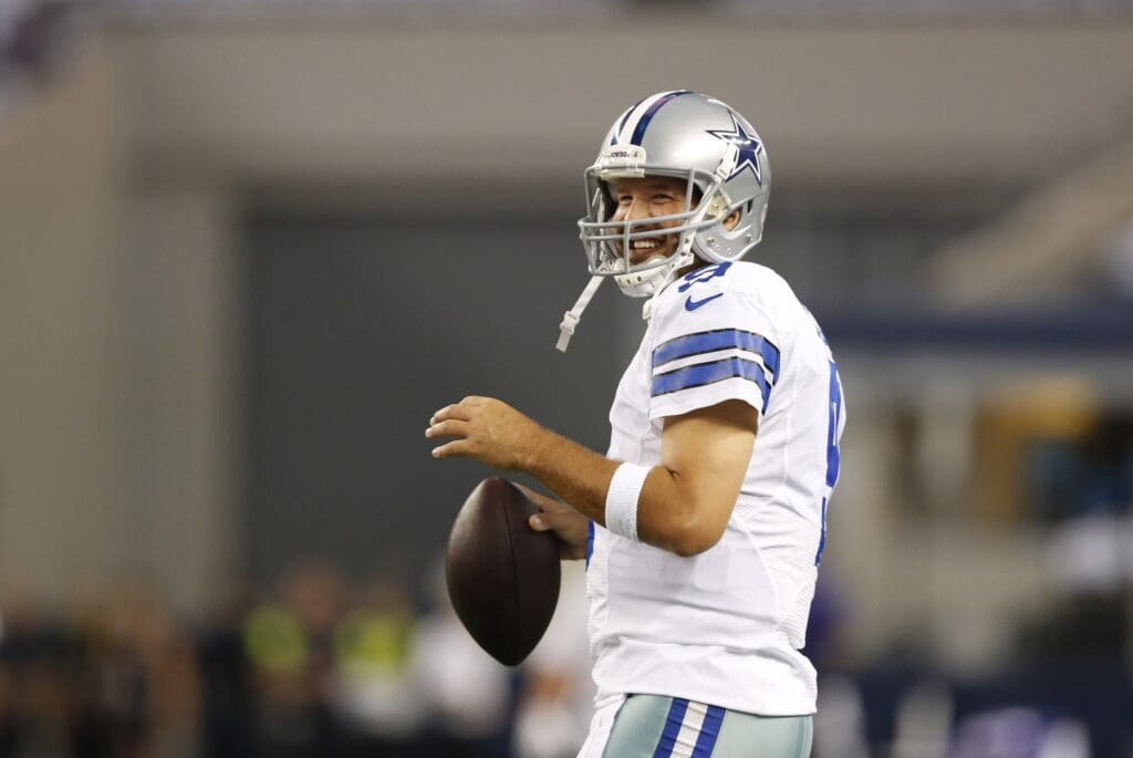 Aug 16, 2014; Arlington, TX, USA; Dallas Cowboys quarterback Tony Romo (9) throws prior to the game against the Baltimore Ravens at AT&T Stadium