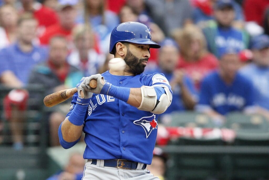 Oct 7, 2016; Arlington, TX, USA; Toronto Blue Jays right fielder Jose Bautista (19) avoids an inside pitch against the Texas Rangers during the second inning of game two of the 2016 ALDS playoff baseball series at Globe Life Park in Arlington.