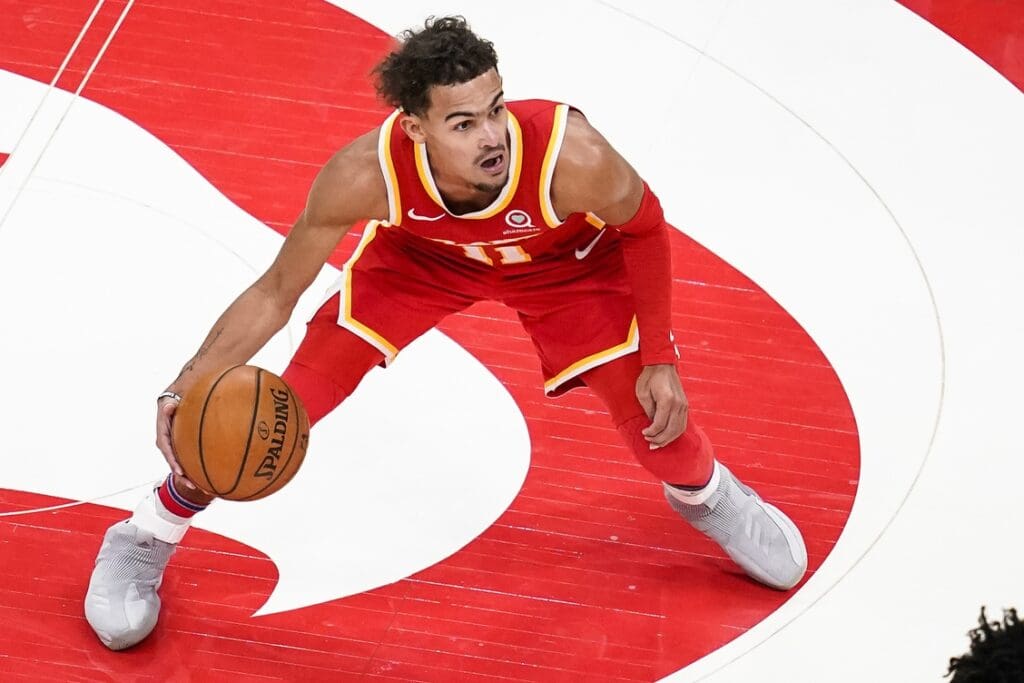 Jan 6, 2021; Atlanta, Georgia, USA; Atlanta Hawks guard Trae Young (11) dribbles against the Charlotte Hornets during the second half at State Farm Arena. 