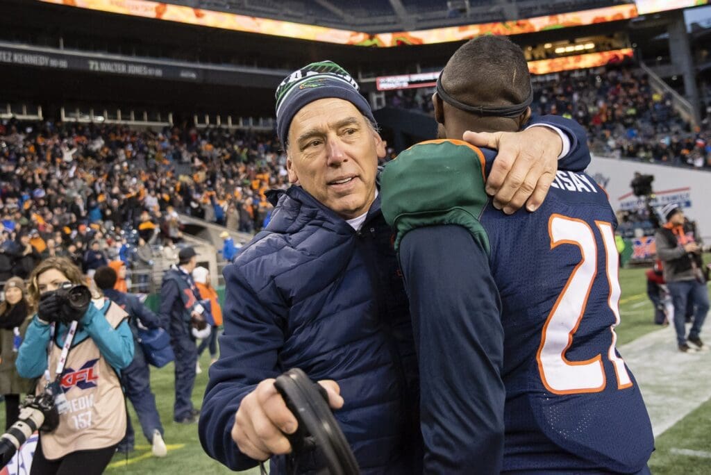 Feb 15, 2020; Seattle, Washington, USA; Seattle Dragons head coach Jim Zorn celebrates with cornerback Mohammed Seisay (21) after defeating the Tampa Bay Vipers at CenturyLink Field. Seattle won 17-9. Mandatory Credit: Troy Wayrynen-USA TODAY Sports