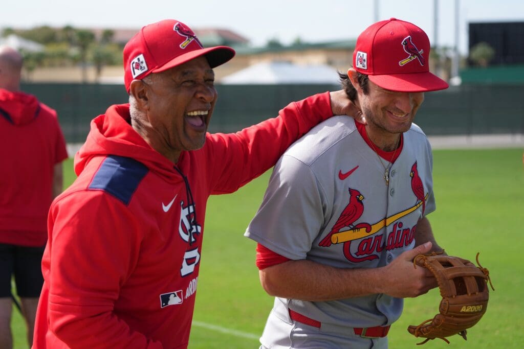 Feb 17, 2025; Jupiter, FL, USA; St. Louis Cardinals legend Ozzie Smith has a laugh with second baseman Thomas Saggese (25) at spring training. Mandatory Credit: Jim Rassol-Imagn Images