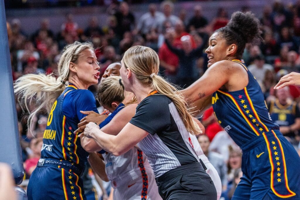 Jun 17, 2025; Indianapolis, Indiana, USA; Indiana Fever guard Sophie Cunningham (8) and Connecticut Sun guard Jacy Sheldon (4) get into a fight in the second half at Gainbridge Fieldhouse. Mandatory Credit: Trevor Ruszkowski-Imagn Images