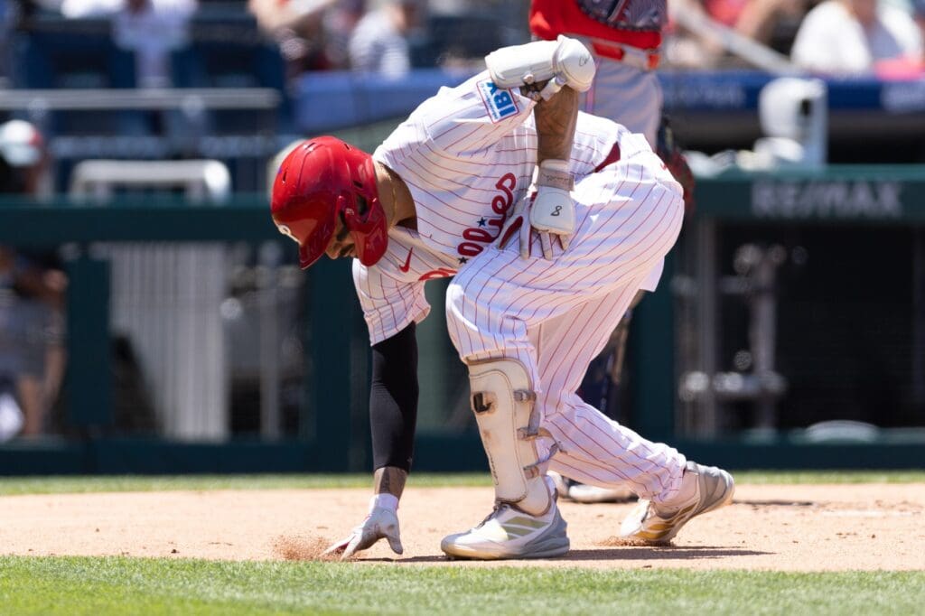Jul 4, 2025; Philadelphia, Pennsylvania, USA; Philadelphia Phillies outfielder Nick Castellanos (8) rubs the dirt at home plater after hitting a two Rbi home run against the Cincinnati Reds during the first inning at Citizens Bank Park. Mandatory Credit: Bill Streicher-Imagn Images