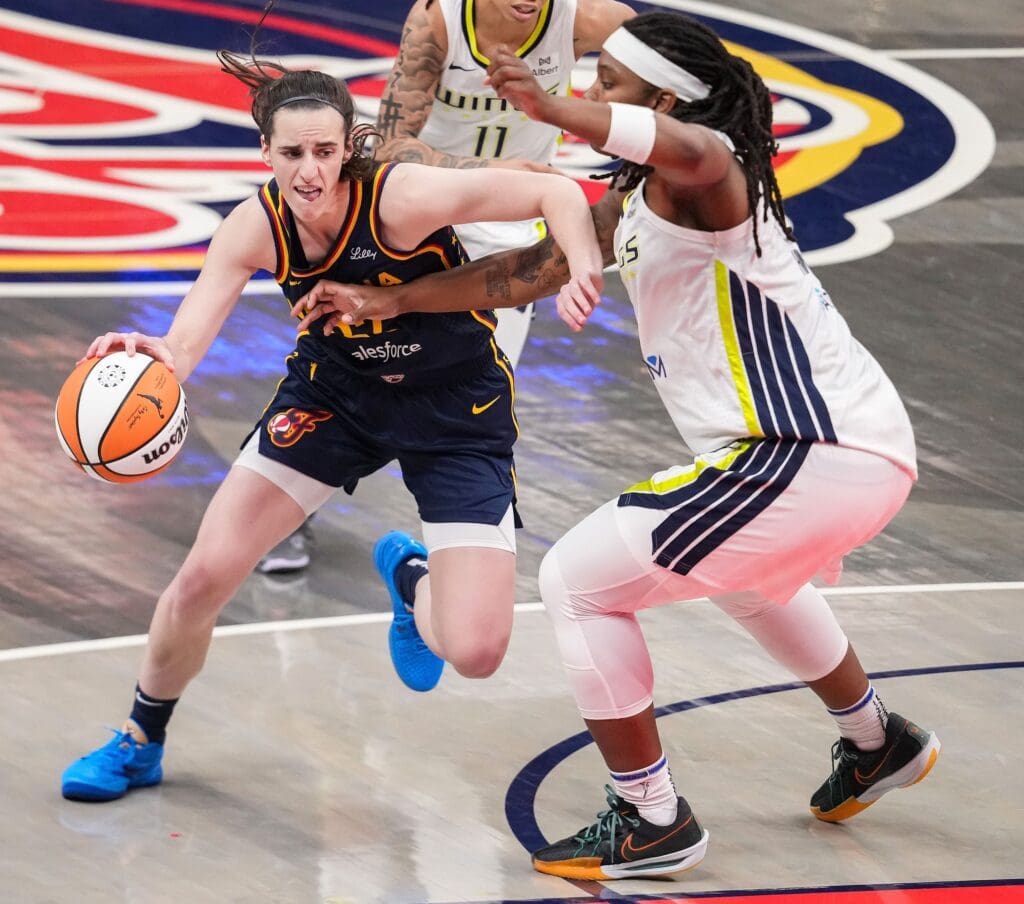 Indiana Fever guard Caitlin Clark (22) rushes up the court against Dallas Wings forward Myisha Hines-Allen (2) on Sunday, July 13, 2025, during the game at Gainbridge Fieldhouse in Indianapolis.