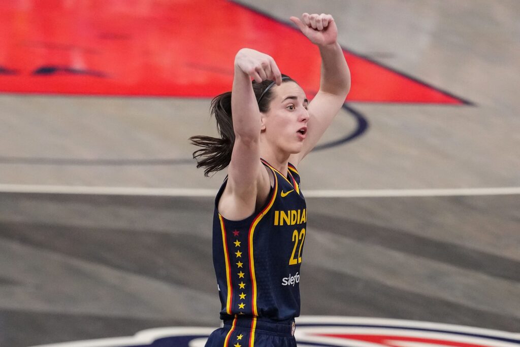 Indiana Fever guard Caitlin Clark (22) shoots the ball from half-court Sunday, July 13, 2025, during the game at Gainbridge Fieldhouse in Indianapolis.