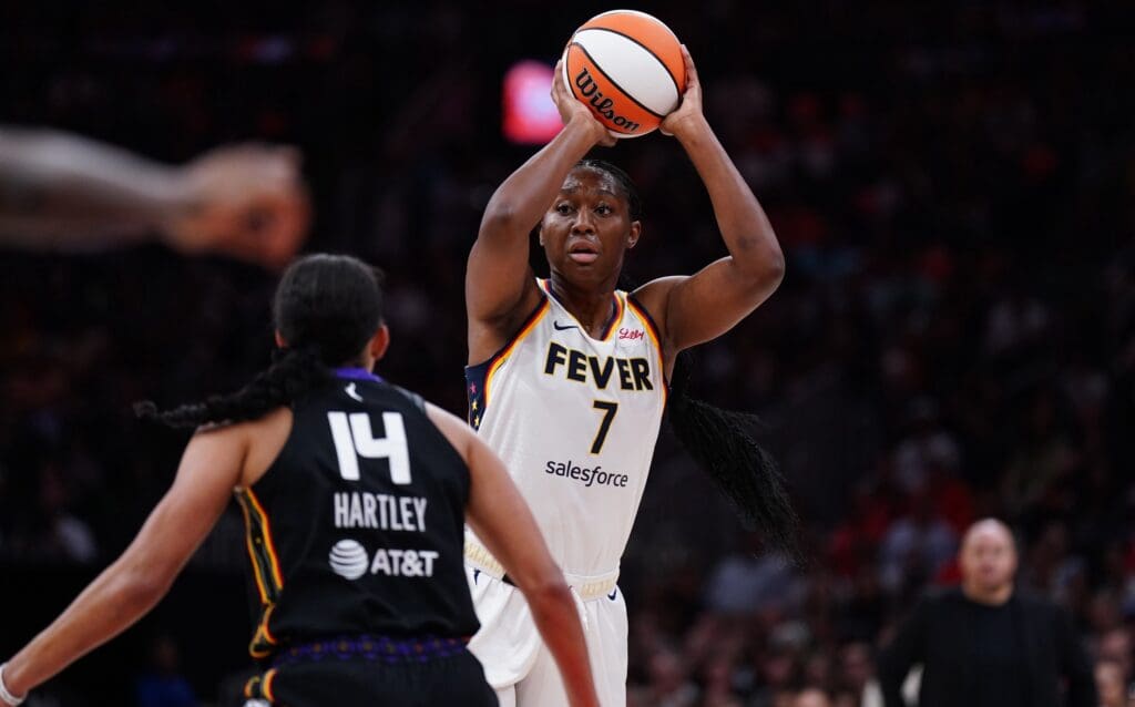 Jul 15, 2025; Boston, Massachusetts, USA; Indiana Fever forward Aliyah Boston (7) looks to pass the ball against Connecticut Sun guard Bria Hartley (14) in the first quarter at TD Garden. Mandatory Credit: David Butler II-Imagn Images