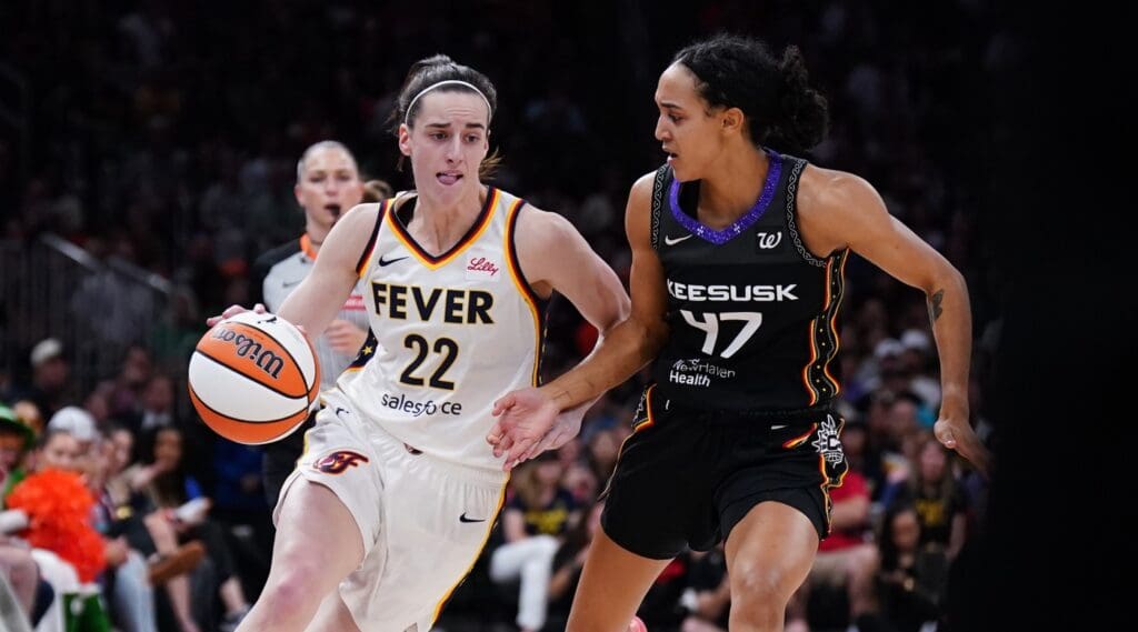 Jul 15, 2025; Boston, Massachusetts, USA; Indiana Fever guard Caitlin Clark (22) drives the ball against Connecticut Sun guard Leila Lacan (47) in the second quarter at TD Garden. Mandatory Credit: David Butler II-Imagn Images