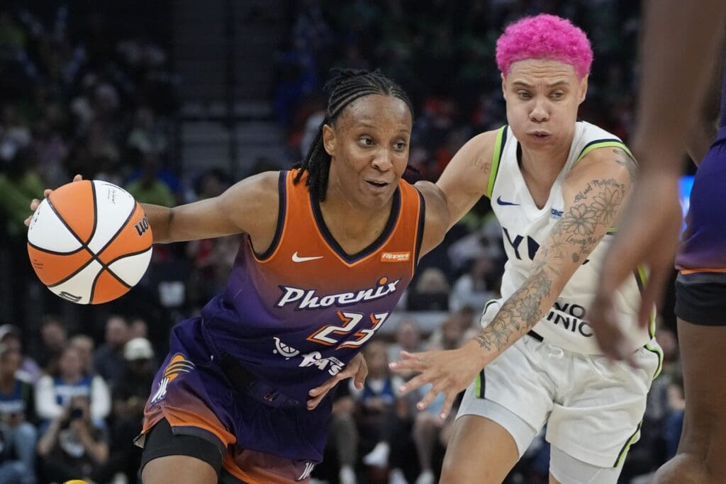 Jul 16, 2025; Minneapolis, Minnesota, USA; Phoenix Mercury guard Kiana Williams (23) drives around Minnesota Lynx guard Natisha Hiedeman (2) in the fourth quarter at Target Center. Mandatory Credit: Bruce Kluckhohn-Imagn Images
