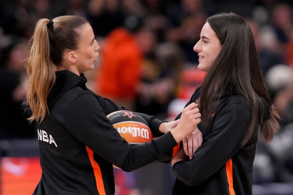 New York Liberty's Sabrina Ionescu (20) and Indiana Fever's Caitlin Clark (22) talk during warmups Saturday, July 19, 2025, ahead of the WNBA All-Star Game at Gainbridge Fieldhouse in Indianapolis.