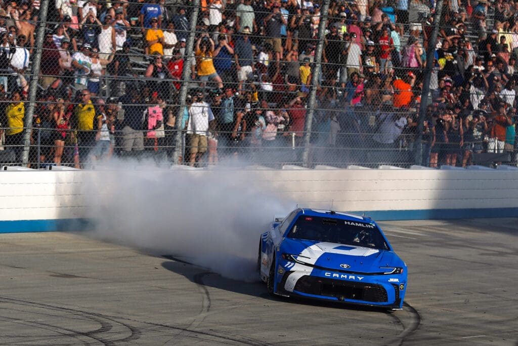 Jul 20, 2025; Dover, Delaware, USA; NASCAR Cup Series driver Denny Hamlin (11) celebrates after winning the Autotrader EchoPark Automotive 400 at Dover Motor Speedway. Mandatory Credit: Matthew O'Haren-Imagn Images