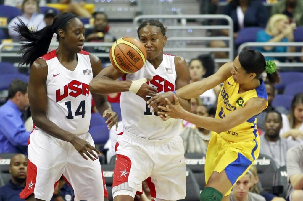 July 16, 2012; Washington, DC, USA; United States forward Tamika Catchings (10) battles for the ball with Brazil guard Castro (8) in the first half at Verizon Center. Team USA won 99-67.
