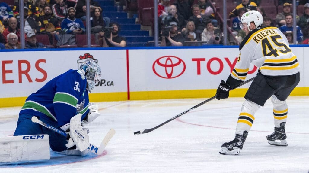 Dec 14, 2024; Vancouver, British Columbia, CAN; Boston Bruins forward Cole Koepke (45) shoots on Vancouver Canucks goalie Thatcher Demko (35) during the third period at Rogers Arena.