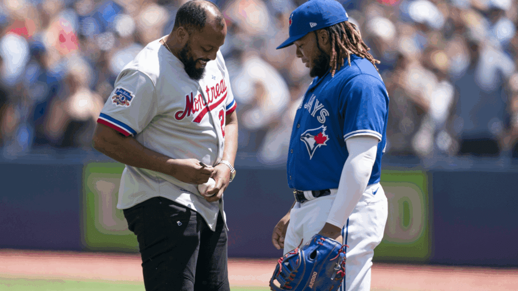 Jul 2, 2022; Toronto, Ontario, CAN; Montreal Expos player Vladimir Guerrero Sr. signs a ball for Toronto Blue Jays designated hitter Vladimir Guerrero Jr. (27) before the game against the Tampa Bay Rays at Rogers Centre