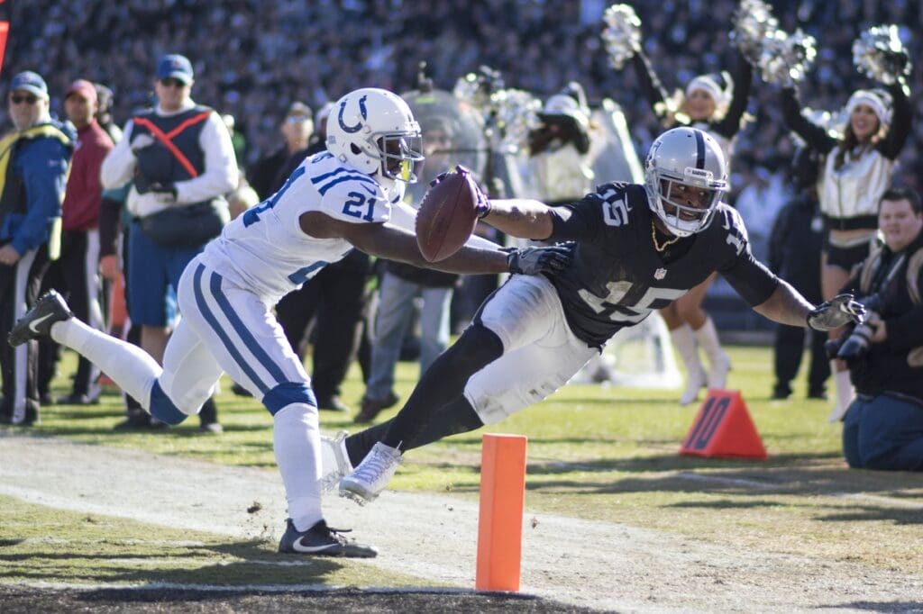 December 24, 2016; Oakland, CA, USA; Indianapolis Colts cornerback Vontae Davis (21) pushes Oakland Raiders wide receiver Michael Crabtree (15) out of bounds during the first quarter at Oakland Coliseum.