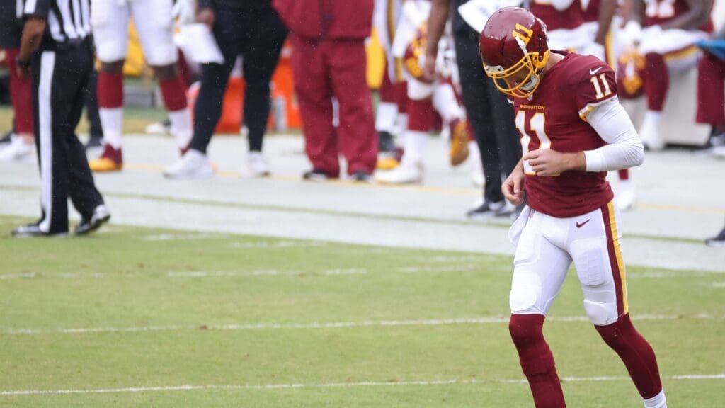 Oct 11, 2020; Landover, Maryland, USA; Washington Football Team quarterback Alex Smith (11) jogs onto the field against the Los Angeles Rams in the second quarter at FedExField.