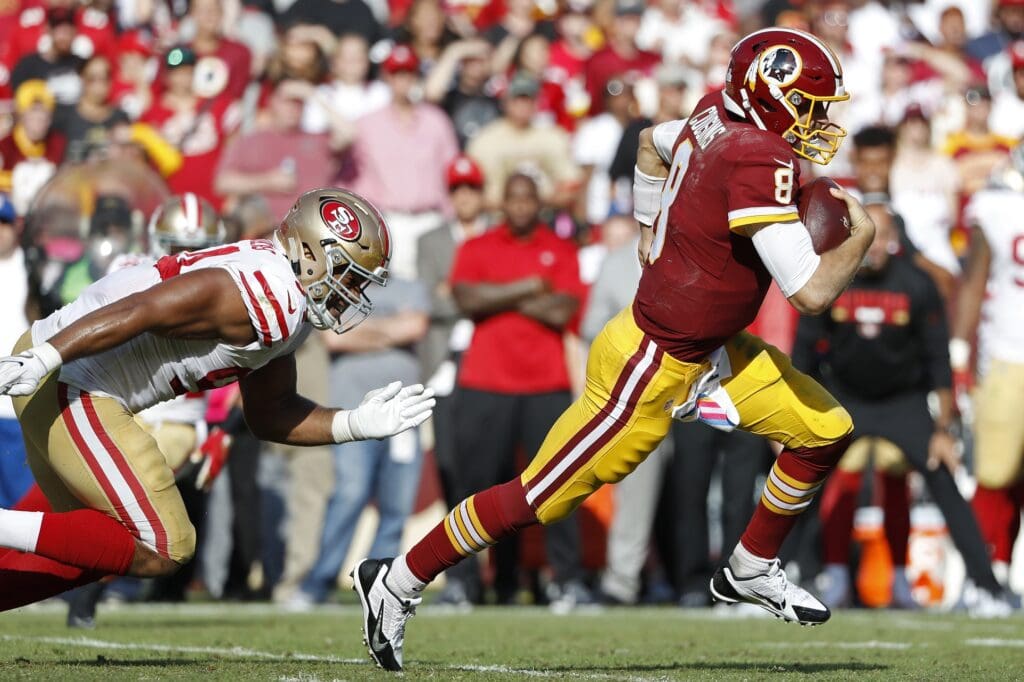 Oct 15, 2017; Landover, MD, USA; Washington Redskins quarterback Kirk Cousins (8) runs with the ball past San Francisco 49ers defensive end Solomon Thomas (94) in the third quarter at FedEx Field. The Redskins won 26-24.