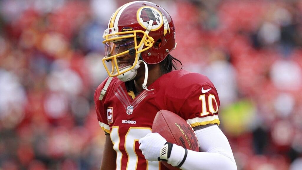 Jan 6, 2013; Landover, MD, USA; Washington Redskins quarterback Robert Griffin III (10) carries the ball prior to Redskins game against Seattle Seahawks at FedEx Field.