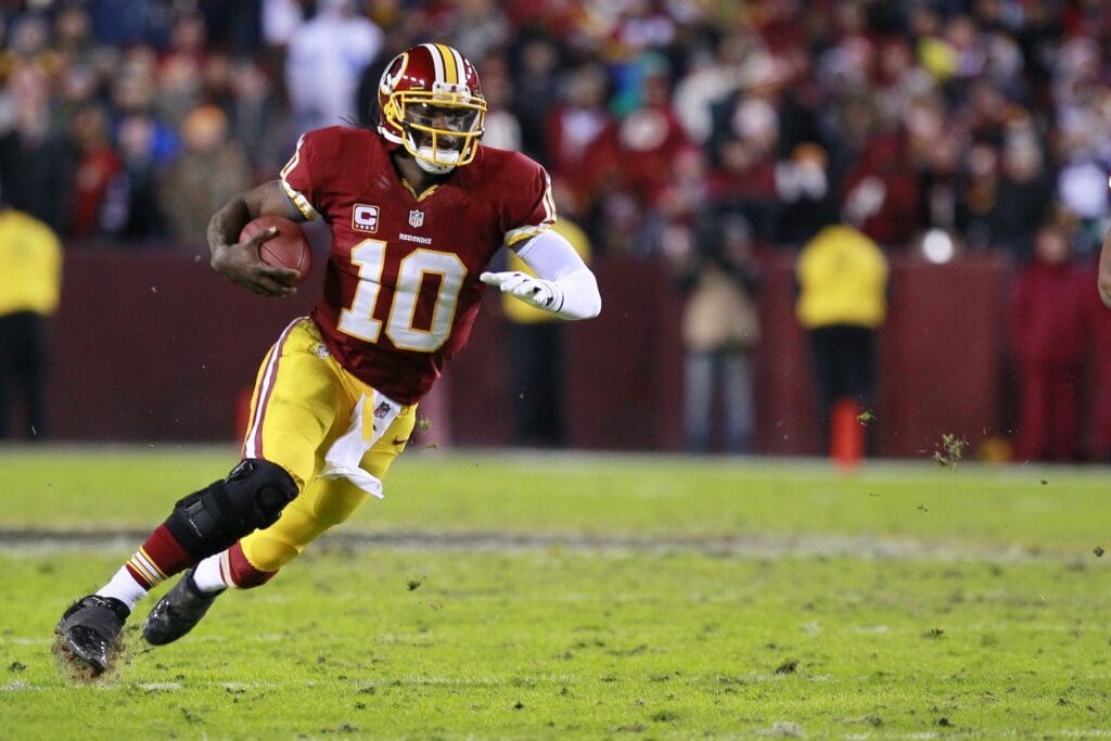 December 30, 2012; Landover, MD, USA; Washington Redskins quarterback Robert Griffin III (10) runs with the ball against the Dallas Cowboys in the second quarter at FedEx Field. 