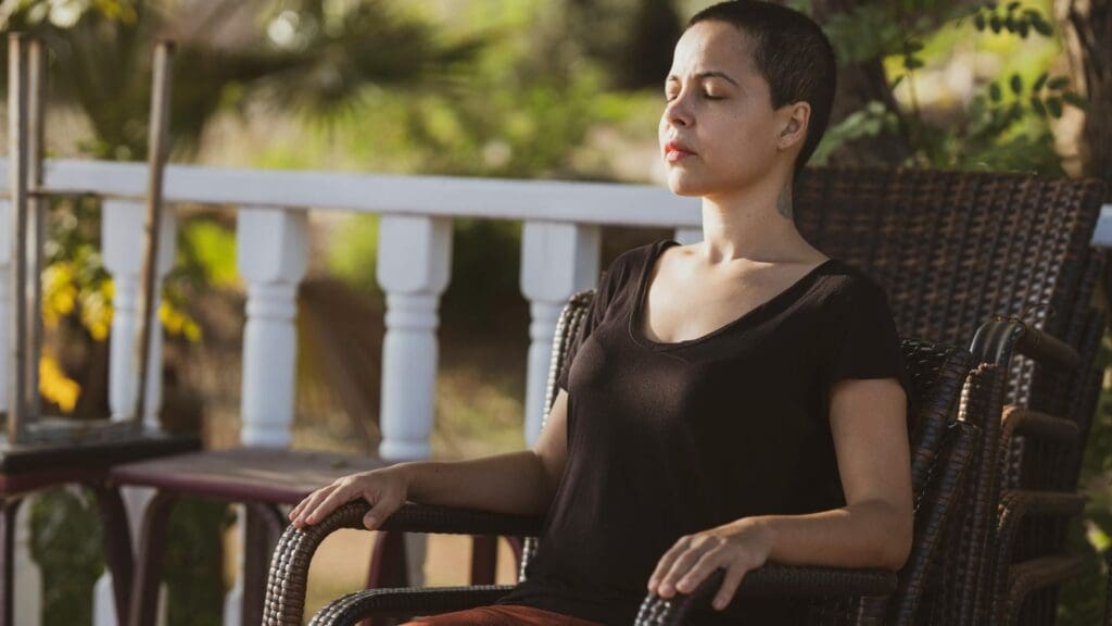Woman in Black Top Sitting on Brown Armchair