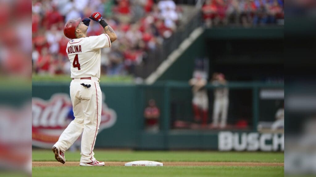 Sep 28, 2013; St. Louis, MO, USA; St. Louis Cardinals catcher Yadier Molina (4) celebrates a two run double off of Chicago Cubs starting pitcher Edwin Jackson (not pictured) during the third inning at Busch Stadium.