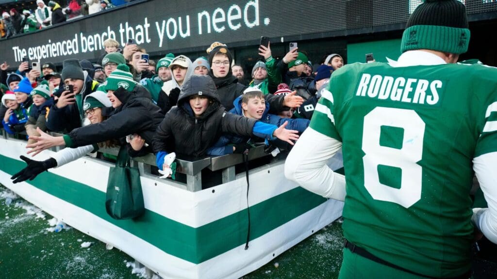Young fans try to get the attention of New York Jets quarterback Aaron Rodgers (8) after the game, Sunday, December 22, 2024, in East Rutherford.