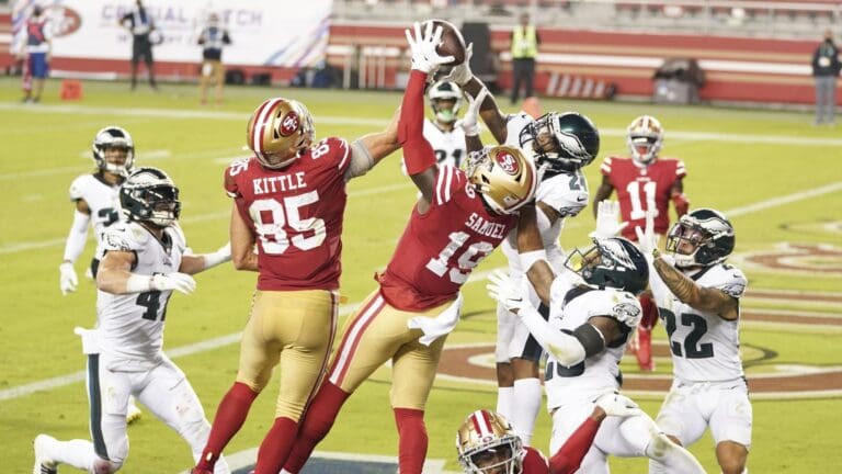 October 4, 2020; Santa Clara, California, USA; San Francisco 49ers tight end George Kittle (85), wide receiver Deebo Samuel (19) and Philadelphia Eagles cornerback Darius Slay (24) reach for the football during the fourth quarter at Levi's Stadium.