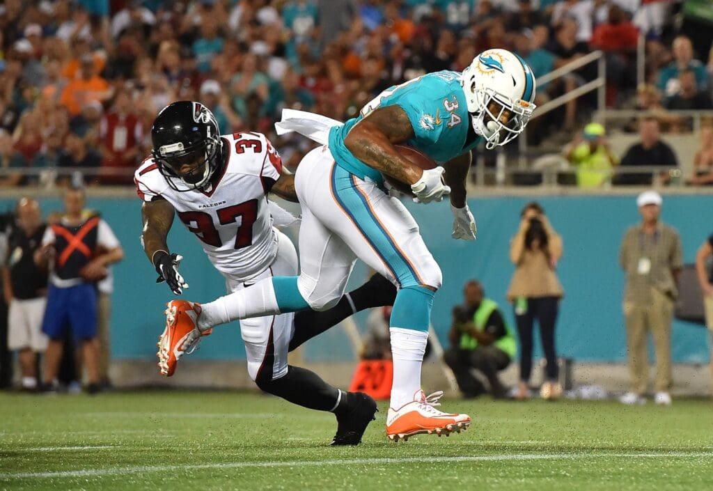 Aug 25, 2016; Orlando, FL, USA; Miami Dolphins running back Arian Foster (34) scores a touch down against the Atlanta Falcons during the first half at Camping World Stadium.