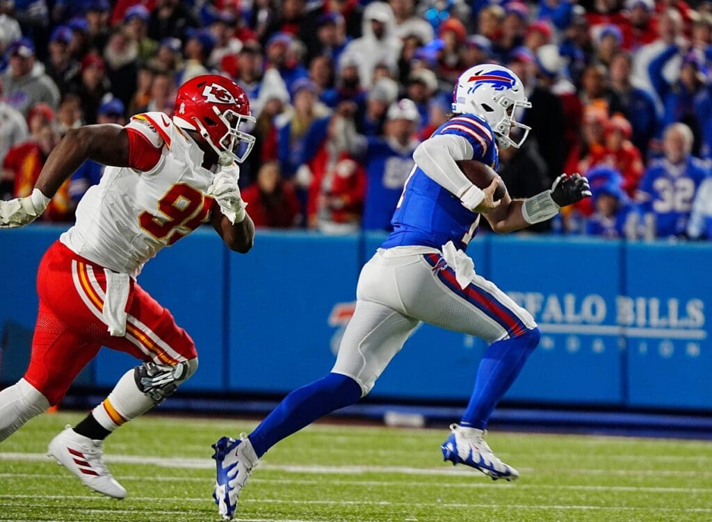 Bills quarterback Josh Allen carries the ball for several yards before sliding to avoid a tackle during first half action against the Kansas City Chiefs in Orchard Park, Nov.17, 2024. Chasing him is Kansas City's Cameron Thomas.
