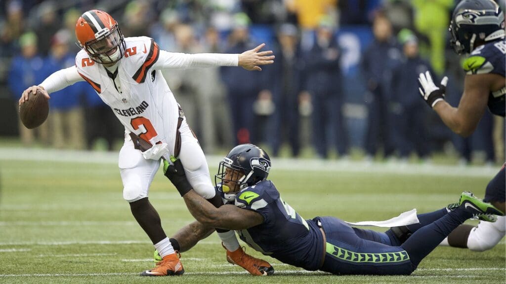 Dec 20, 2015; Seattle, WA, USA; Cleveland Browns quarterback Johnny Manziel (2) get away a pass as he is tackled Seattle Seahawks linebacker Bruce Irvin (51) during a game at CenturyLink Field.