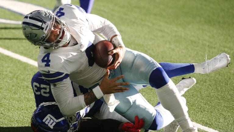 Oct 11, 2020; Arlington, Texas, USA; Dallas Cowboys quarterback Dak Prescott (4) is tackled and injured by New York Giants cornerback Logan Ryan (23) in the third quarter at AT&T Stadium.