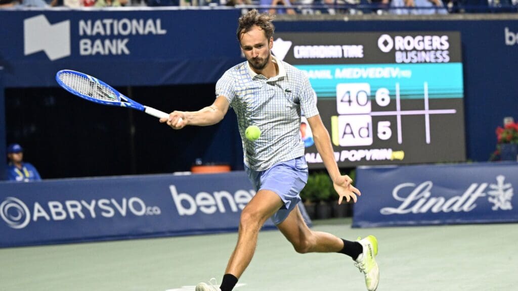 Jul 31, 2025; Toronto, ON, Canada; Daniil Medvedev plays a shot against Alexei Popyrin (AUS) during third round play at Sobeys Stadium.