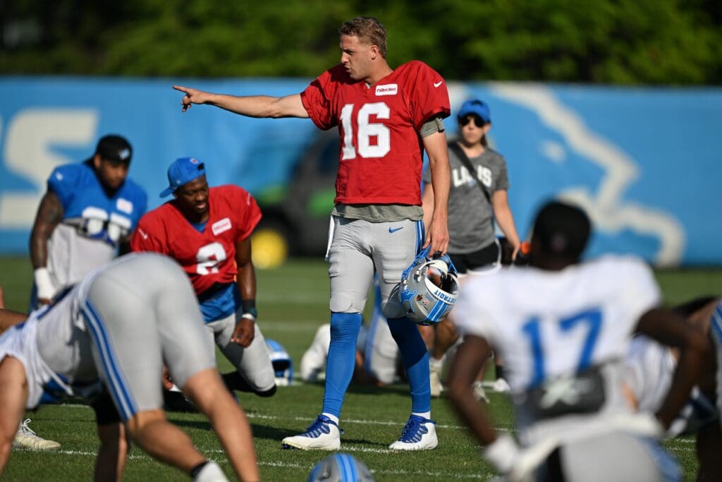 Jul 28, 2025; Allen Park, MI, USA; Detroit Lions quarterback Jared Goff (16) gives directions to his teammates as they finish stretching during training camp at Meijer Performance Center.