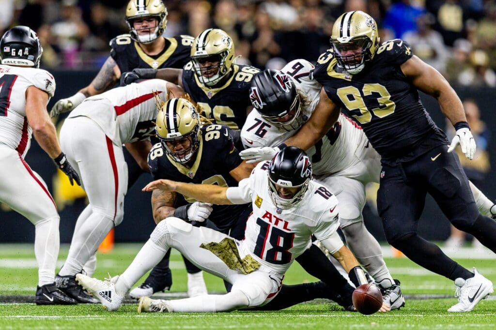 Nov 10, 2024; New Orleans, Louisiana, USA; New Orleans Saints defensive end Chase Young (99) forces a fumble by New Orleans Saints quarterback Spencer Rattler (18) as he is sacked during the second half at Caesars Superdome.