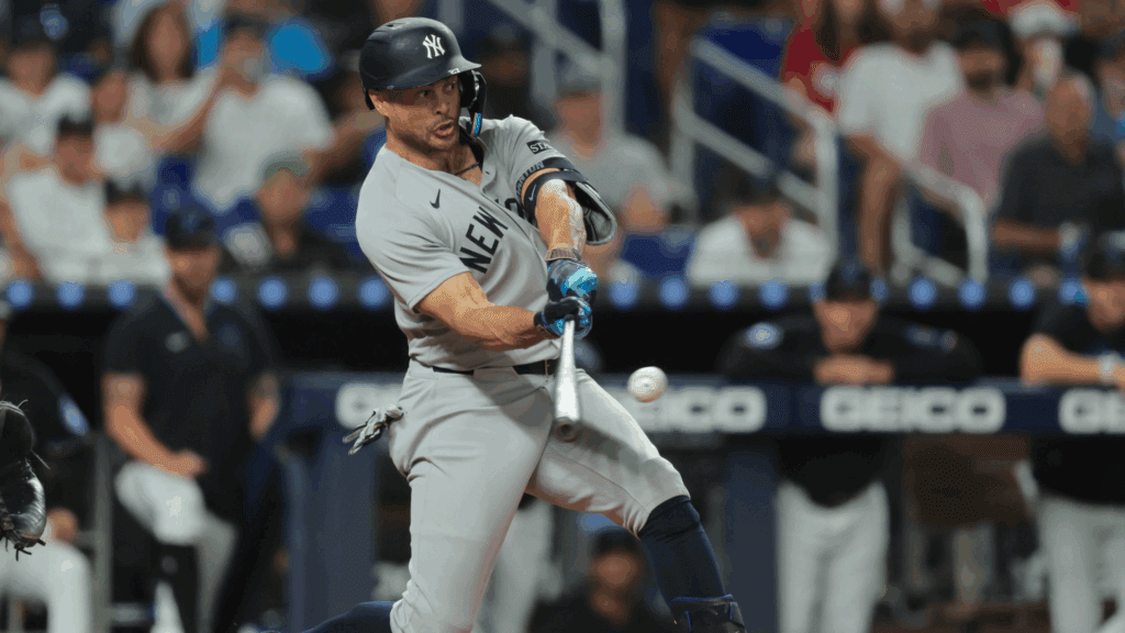 Aug 1, 2025; Miami, Florida, USA; New York Yankees designated hitter Giancarlo Stanton (27) hits a three-run home run against the Miami Marlins during the fourth inning at loanDepot Park.
