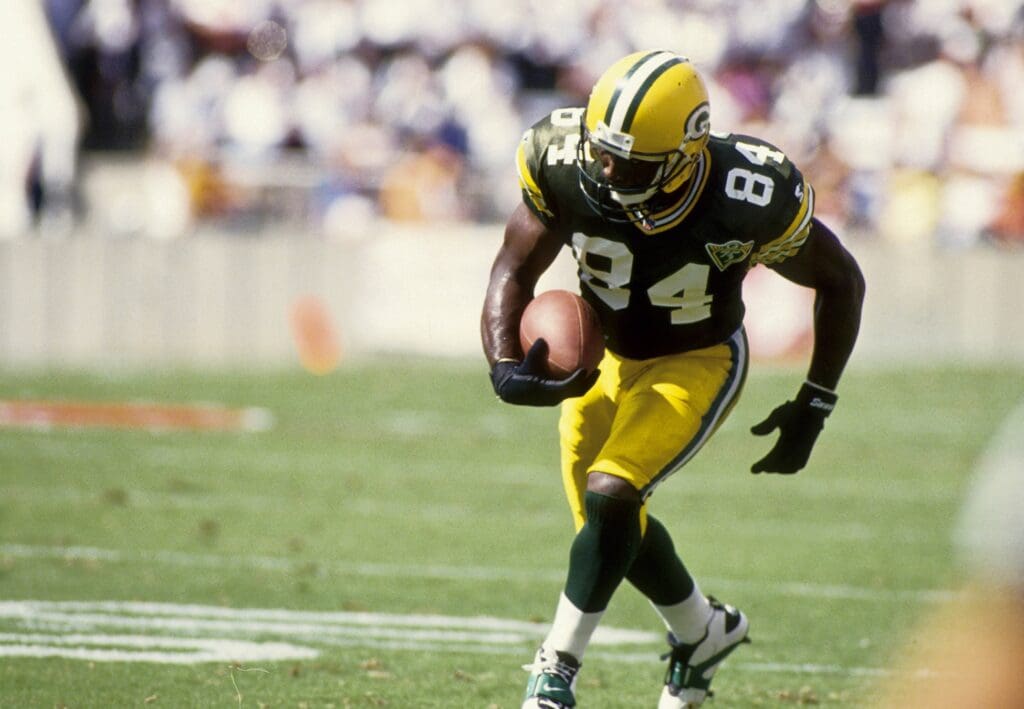 Oct 24, 1993; Tampa, FL, USA; Green Bay Packers receiver Sterling Sharpe (84) scores a touchdown against the Tampa Bay Buccaneers at Tampa Stadium. 